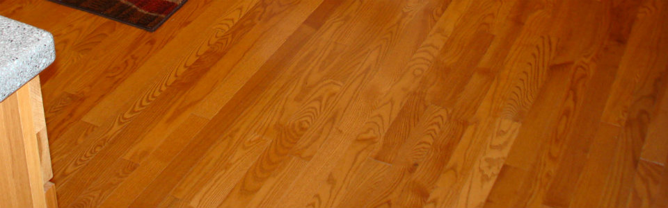 Oak stained hardwood floors in an updated kitchen.