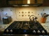 Ceramic Tile Backsplash with Tumbled Stone Accent Focal Point